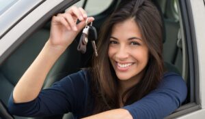 Young Happy Woman Showing The Key Of New Car
