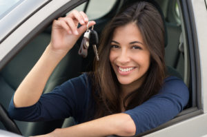 Young Happy Woman Showing The Key Of New Car